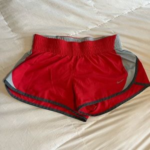 Women’s Nike Dri-Fit Mid-Rise 2.5” Red Athletic Shorts.